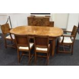 An Art Deco walnut dining suite comprising sideboard with a stepped top,