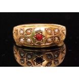 A late 19th Century 15ct hallmarked ruby and seed pearl seven stone boat shaped ring,