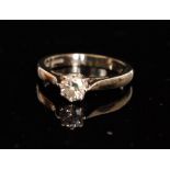 A modern hallmarked 18ct white gold solitaire diamond ring,