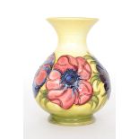 A Moorcroft vase of globe and shaft form decorated in the Anemone pattern with tubelined flowers