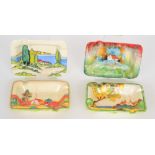 A set of four tribute rectangular ashtrays each hand painted by Terry Abbots with a landscape scene