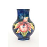 A small Moorcroft footed vase decorated in the Frilled Orchid pattern, impressed mark, height 10.