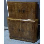 An Art Deco figured walnut cocktail or drinks cabinet of stepped form,