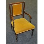 A late 19th to early 20th Century rosewood salon open armchair with turned frame.