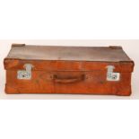 A pig skin stitched brown suitcase with lined interior,