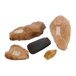 Three Paleolithic stone flint knapped axe heads together with a fragment and smoothed axe head,
