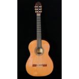 A Spanish Raimundo model 128 classical guitar and hard carrying case.