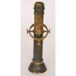 A 19th Century brass ships gimbal candlestick with swivel mount inscribed H.M.