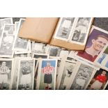 A collection of Tropical times black and white football cards, some tinted with colour.