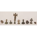 A collection of Medieval bronze seals to include two trefoil handle examples with bird and star