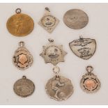 Nine assorted silver and metal sporting fobs to include a 1920-21 Football League R.A.