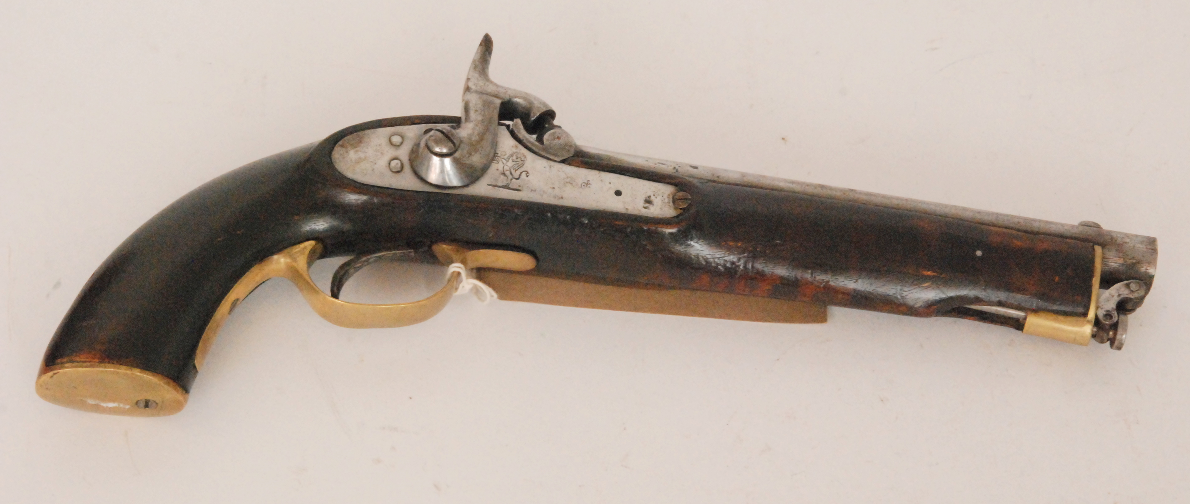 A 19th Century East India Company percussion holster pistol with ram rod brass trigger guard and