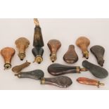 A collection of 19th Century embossed copper powder flasks with leather and a horn example and