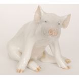 A Royal Copenhagen figure of a seated pig, model 414, height 16.