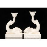 A pair of Wedgwood creamware candlesticks modelled as grotesque fish with its tail in the air,