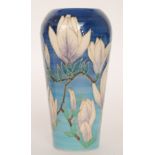 A Dennis China Works vase designed by Sally Tuffin decorated with magnolia flowers against a blue