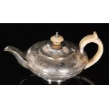 A George IV hallmarked silver melon shaped bachelors tea pot with foliate engraved decoration,