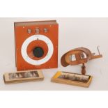 An Edwardian mahogany stereoscopic viewer with various views and social history cards,