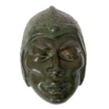 A 1930s cast bronze face mask in the Art Deco taste modelled as an Oriental gentleman with stylised