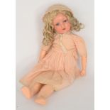 An early 20th Century doll with blue glass eyes and open mouth showing teeth and blonde curl locks