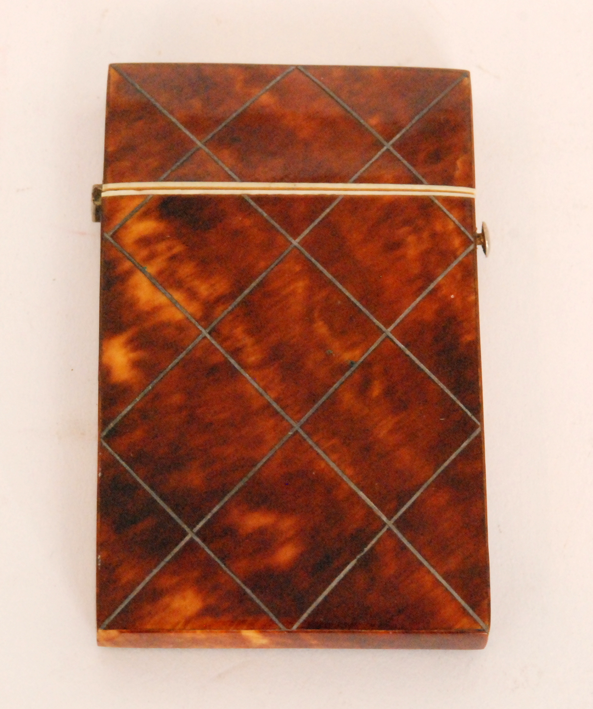 A small 19th Century tortoiseshell card case of inlaid silver cross hatch design, 9cm x 5.