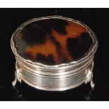 An early 20th Century hallmarked silver and tortoiseshell circular trinket box of plain form,