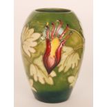 A Moorcroft vase of ovoid form decorated in the Columbine pattern against a green ground,