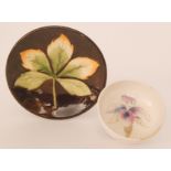 A Moorcroft pin dish decorated with a large maple leaf against a brown ground, impressed mark,