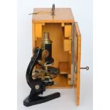 An early 20th Century German microscope by Dr A Scroder Kassel in fitted wooden case.