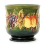 A Moorcroft Pottery jardiniere of footed circular form decorated in the Fruiting Vine pattern over