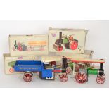 A Mamod live steam roller and a steam tractor with a lumber and an open wagon, all boxed,