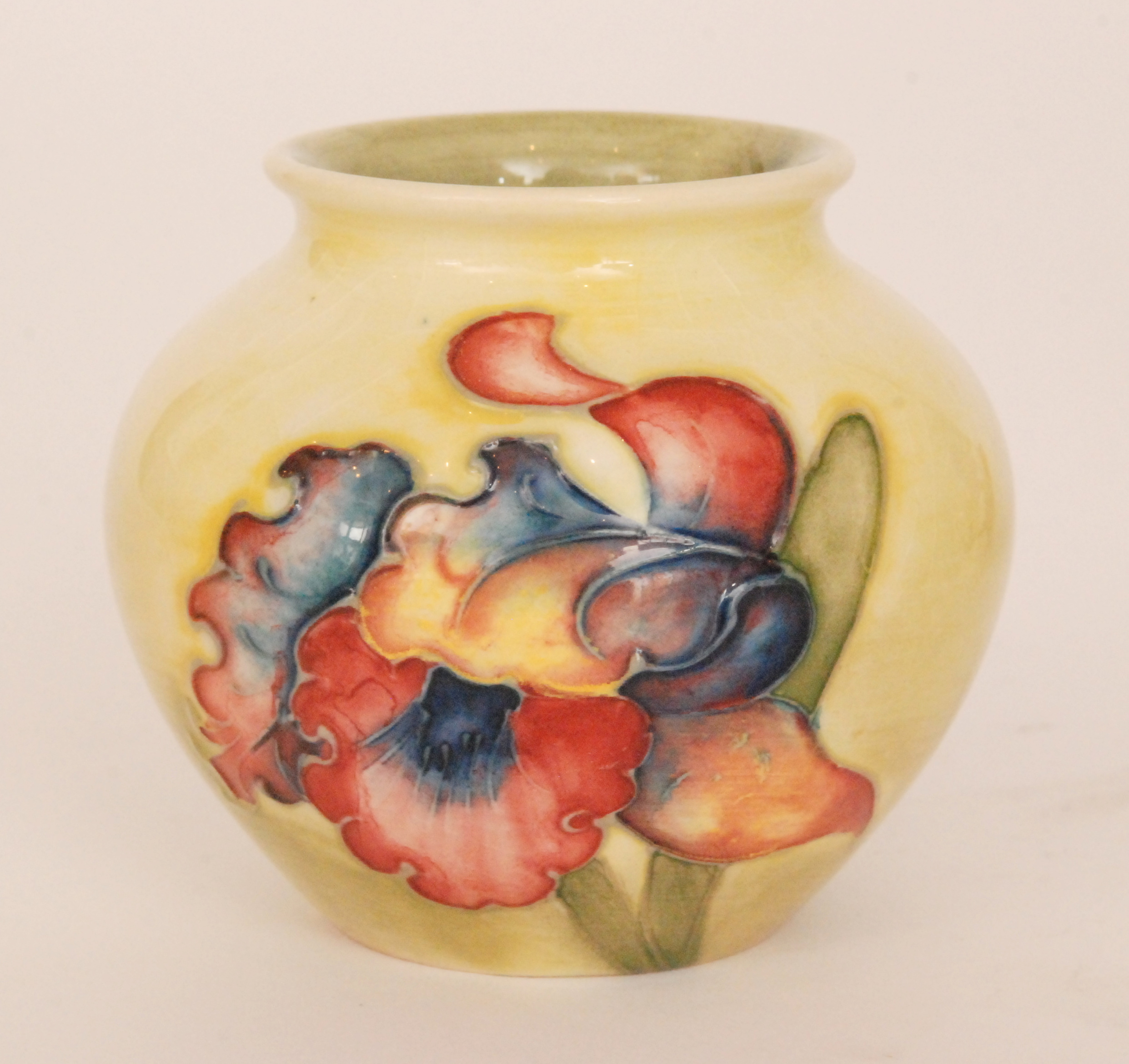 A Moorcroft vase of ovoid form decorated in the Frilled Orchid pattern against a yellow to green