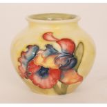 A Moorcroft vase of ovoid form decorated in the Frilled Orchid pattern against a yellow to green