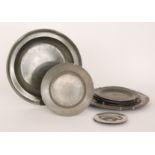 An 18th Century pewter dish with raised rim and line edged border, diameter 37cm,