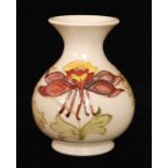 A Moorcroft vase of footed ovoid form with a flared collar neck decorated in the Columbine pattern