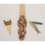 An early 20th Century celluloid paper knife the handle modelled as a coiled dragon,