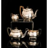 A George III hallmarked silver three piece tea service of oval outline composed of teapot,