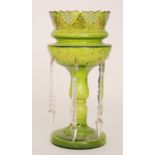 A late 19th Century green glass table lustre of footed form with baluster stem and ovoid bowl