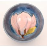 A Moorcroft high sided footed bowl decorated in the Magnolia pattern with a pink flower against a