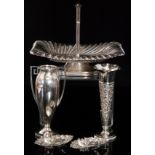 An Edwardian hallmarked silver trumpet vase embossed cherub and scroll decoration below wavey rim,