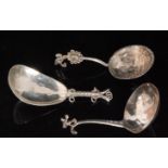 Three 19th Century Continental silver short spoons, one decorated with a pastoral scene,