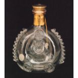 A Remy Martin brandy bottle made by Baccarat of compressed ovoid form with applied decorative