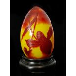 Daum - An early 20th Century cameo glass egg cased in ruby over citron and cut with a slipper
