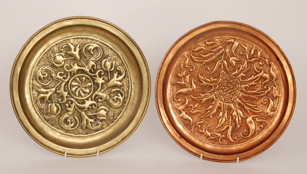 The Keswick School of Industrial Art - A copper charger with repousse work stylised thistle head