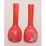 Kralik - A pair of early 20th Century vases with a triform base below a tall slender collar neck,