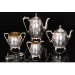A Victorian silver plated aesthetic style four piece tea set part engraved stiff leaf and scroll