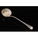 A George III hallmarked silver Old English pattern ladle with shell bowl below feather edged
