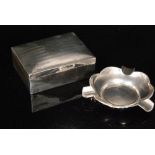 A hallmarked silver cigarette box with engine turned decoration,