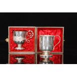 A Victorian cased silver plated pedestal christening cup terminating in twisted scroll handle,