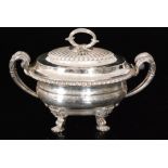 A composed George III hallmarked silver sauce tureen and cover of plain form with twin split